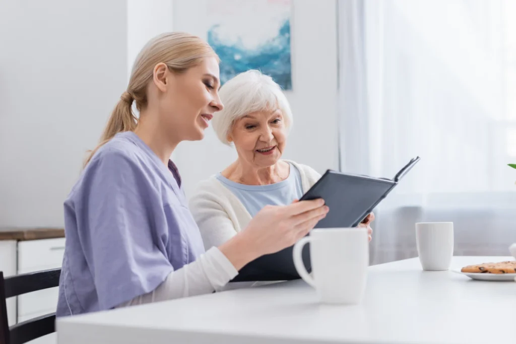 Caregiver helping senior woman in memory care